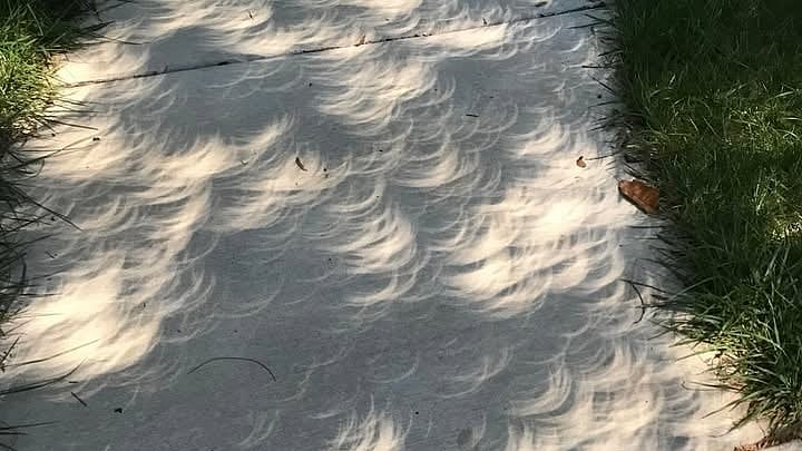 A solar eclipse above, the moon's shadow below: 13 stunning photographs