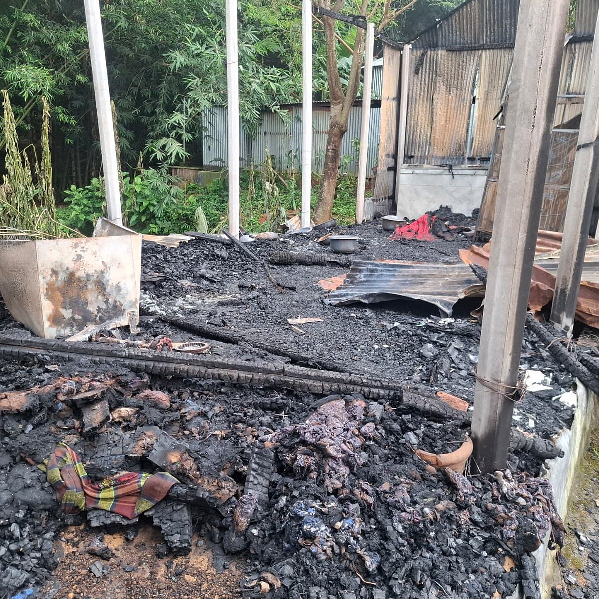 Door chained shut and set alight; couple survive by cutting through the tin wall